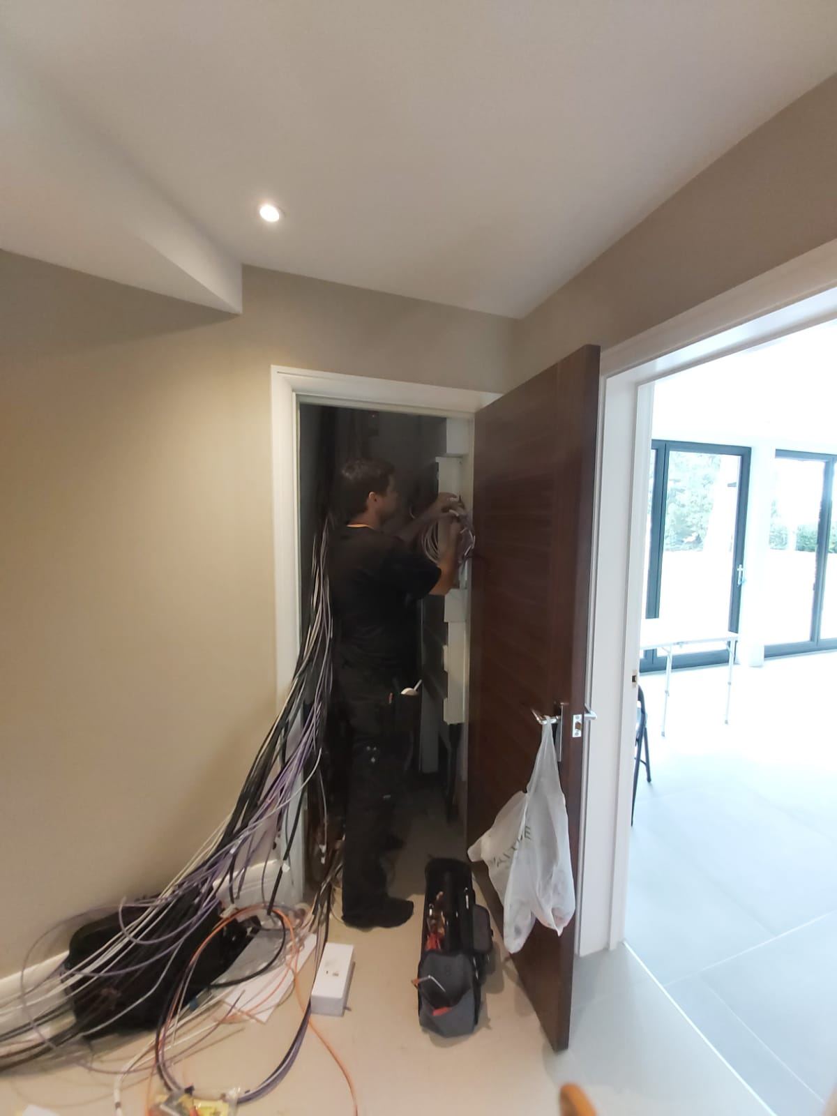 Engineer completing cable wiring for a security installation