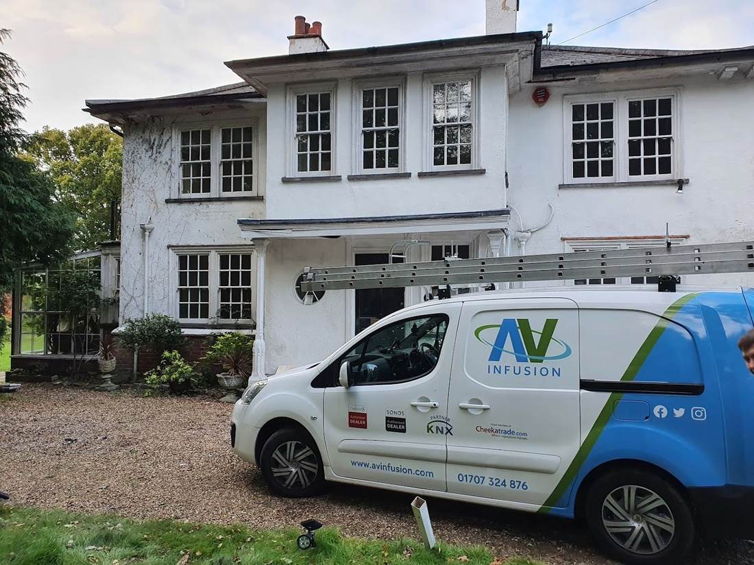 AV Infusion service van parked outside a period property in Hertfordshire during a job