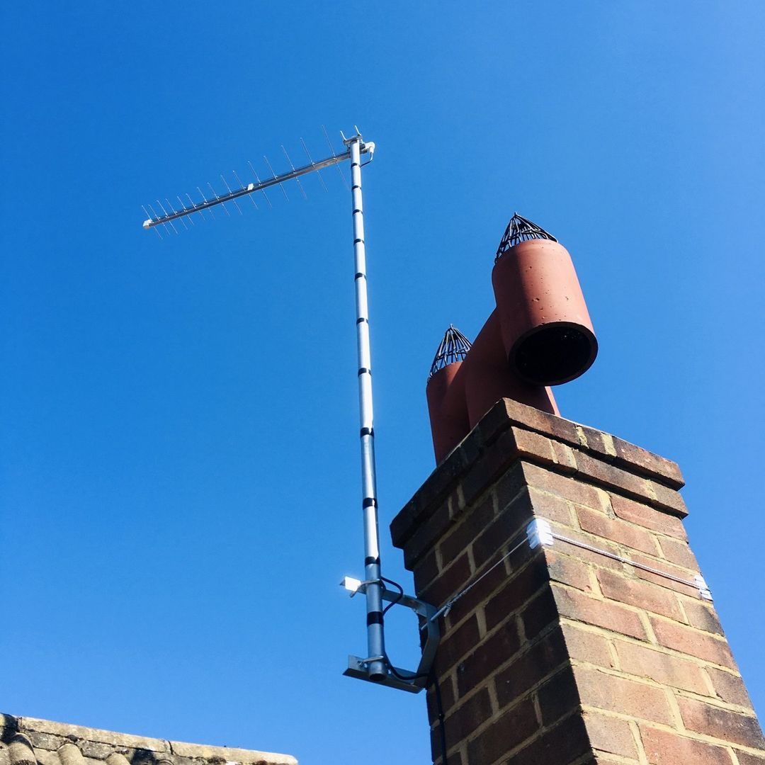 TV aerial and chimney pots on a rooftop in Hertford