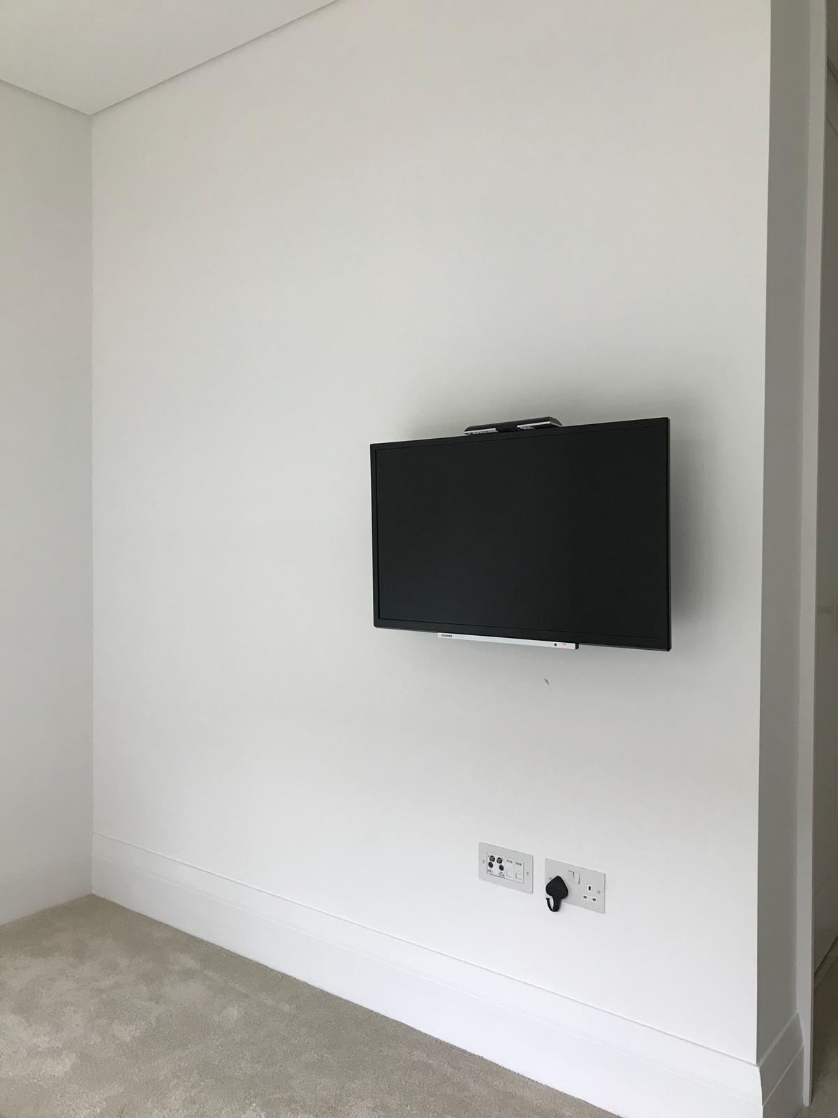 Wall-mounted television with cables neatly concealed