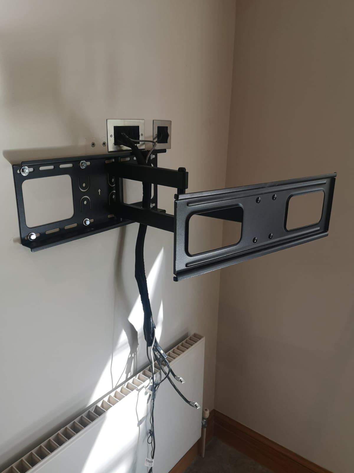TV wall-mount bracket fixed to an interior wall